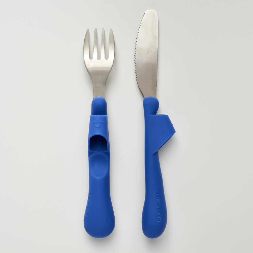 Kinder Cutlery fork and knife set, made of stainless steel and blue food-grade silicone handles, on a light gray background